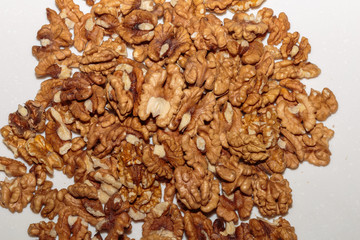 Heap kernels of walnut on a kitchen table. Concept of healthy vegan food.