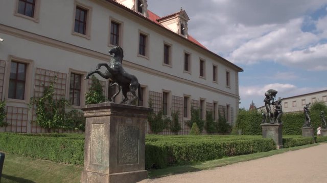 The statue of the horse among the other sculptures in the Wallenstein garden in Prague.