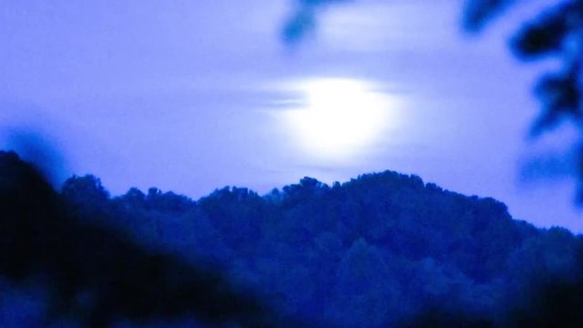 full moon abstract timelapse over mountains