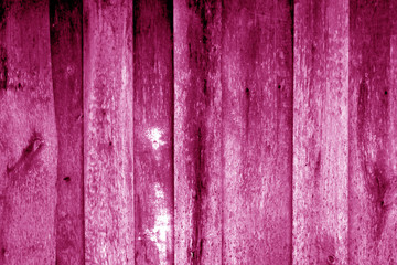 Obraz premium Weathered wooden fence in pink color.