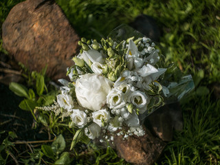 bouquet of flowers surrounded by grass and stones