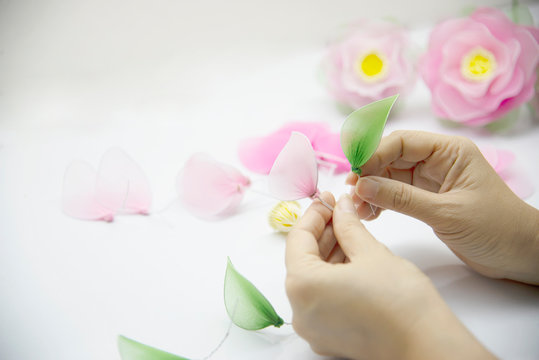 Woman making beautiful nylon flower - people with DIY handmade flower concept