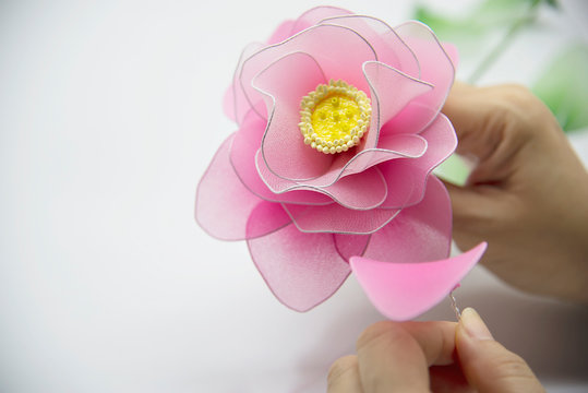 Woman making beautiful nylon flower - people with DIY handmade flower concept