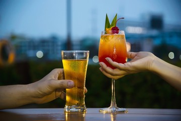 Couple celebration in restaurant with soft drink beer and mai tai or mai thai - happy lifestyle...