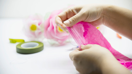 Woman making beautiful nylon flower - people with DIY handmade flower concept