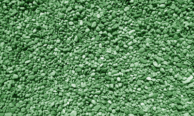 Pile of small gravel stones in green tone.