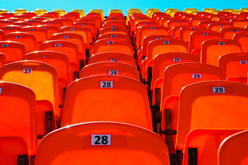Naklejka premium empty tribune for fans on a sunny day. combination of orange and blue