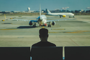 boy listening to music at the airport