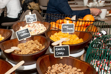 Selection of self service catering continental breakfast buffet display, catering or brunch table food buffet filled with all sorts of delicious food, cereal display in a hotel or restaurant setting