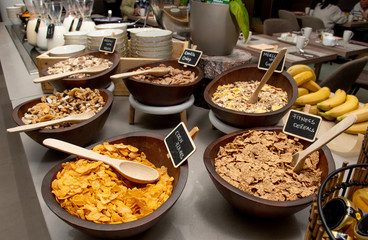 Selection of self service catering continental breakfast buffet display, catering or brunch table food buffet filled with all sorts of delicious food, cereal display in a hotel or restaurant setting