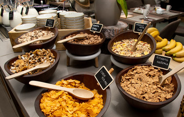 Selection of self service catering continental breakfast buffet display, catering or brunch table food buffet filled with all sorts of delicious food, cereal display in a hotel or restaurant setting