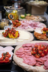 Selection of self service catering continental breakfast buffet display, catering or brunch table food buffet filled with all sorts of delicious food, meat platters in a hotel or restaurant setting
