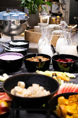 Selection of self service catering continental breakfast buffet display, catering or brunch table food buffet filled with fresh fruits, cereals and milk in a hotel or restaurant setting