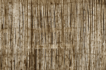 Weathered bamboo fence in brown tone.