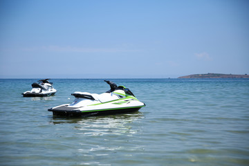 two jet skis in the open ocean. hydrocycles on the sea surface. personal watercrafts are ready to ride