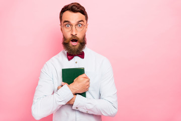 Close up photo of stunned shocked guy hugging book with green cover isolated pastel background