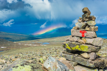 Stone sign on Norway's most beautiful mountain trek across the Besseggen ridge, Jotunheimen National Park, Norway