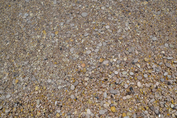 Sea stones in the sea water. Pebbles under water. The view from the top. Nautical background. Clean sea water. Transparent sea.