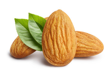 Obraz na płótnie Canvas Close-up of three almonds with leaves, isolated on white background