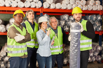 Logistics team with young woman as apprentice