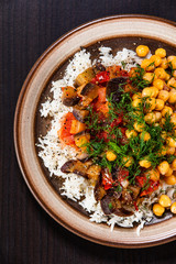 Rice with chickpea and vegetables on wooden table