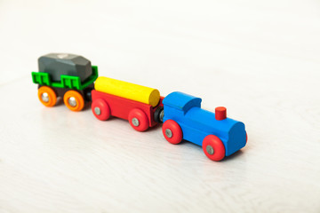 Obraz premium Child'd wooden train on the white floor