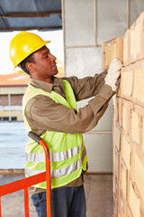 Warehouse worker picks up a package from the warehouse