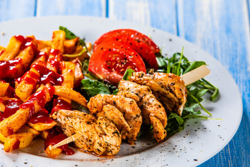 Fried chicken strips, french fries and vegetables
