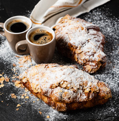 Croissants with almonds on the black background