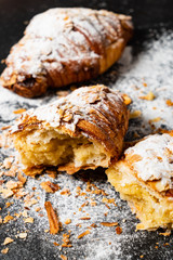 Croissants with almonds on the black background