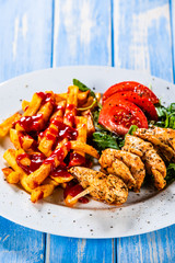 Fried chicken strips, french fries and vegetables