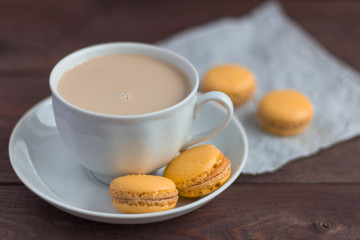 macaroons, delicious almond cookies and a Cup of coffee with cream on the table