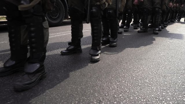A detachment of soldiers built in one line. Special police unit in anticipation of the order of the commander. Soldiers in green camouflage, body armor and black boots. The military defend the borders