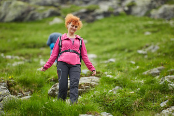 Naklejka na ściany i meble Woman hiker with backpack