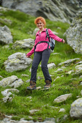 Naklejka na ściany i meble Woman hiker with backpack