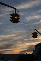 Traffic light with yellow light against the evening sky in USA.  Selective focus.