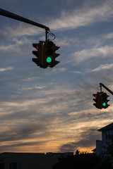 Traffic light with red light against the evening sky in USA.  Selective focus.