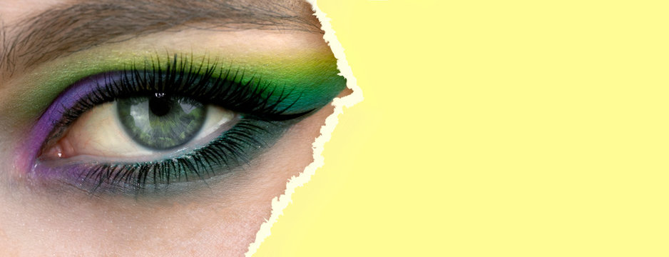 Banner with female eye makeup, closeup. Makeup with bright eye shadows. On eyes beautiful model girl's apply makeup yellow - green eye shadow.