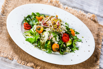 Salad with white rice on wooden background