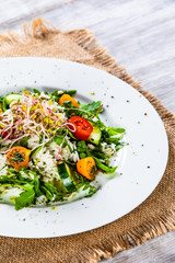 Salad with white rice on wooden background