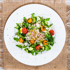Salad with white rice on wooden background