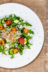 Salad with white rice on wooden background
