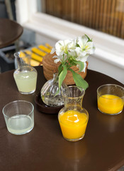 Refreshing orange and lime juices on a table lay-out