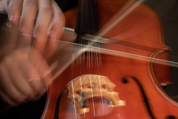A young cellist practices intensely in this close up high resolution photo of strings, cello, and...