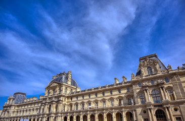 Obraz premium Paris, France - April 21, 2019 - A view of the Louvre Museum, the world's largest art museum and a historic monument in Paris, France, on a sunny day.