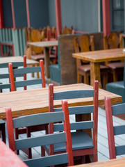 small local cafe with terracota tables and painted chairs