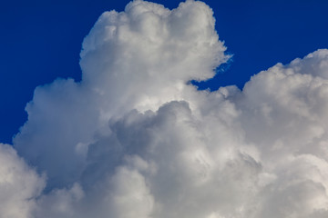 Clouds over blue sky. Sunny day and moment before the summer storm.