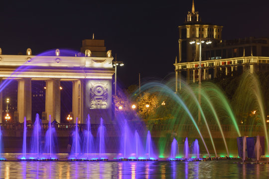 Long exposure image of the fountain spray in blue neon illumination. Coolorful bright night in the Gorky Park in Moscow. High resolution photo.