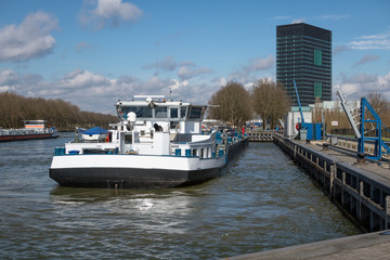 Fototapeta na wymiar Dutch Amsterdam-Rijn canal with ship mooring at oil transit point