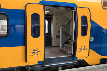 Train at Dutch railway platform with open door